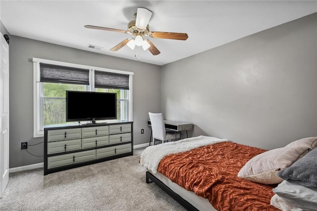 bedroom with baseboards, a ceiling fan, visible vents, and carpet