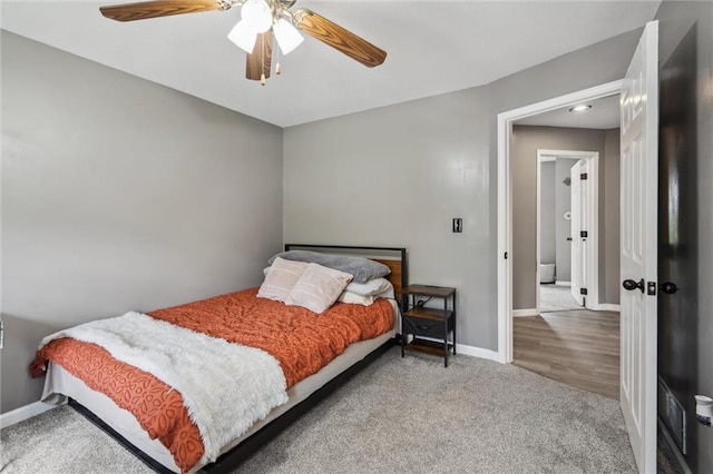 carpeted bedroom featuring a ceiling fan and baseboards