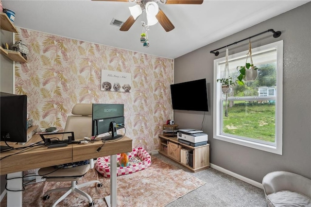 home office with a ceiling fan, visible vents, carpet flooring, and a healthy amount of sunlight