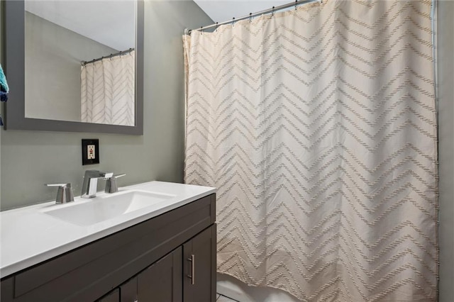 full bath featuring vanity and a shower with shower curtain