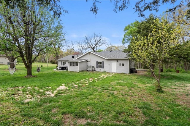 rear view of house featuring a yard