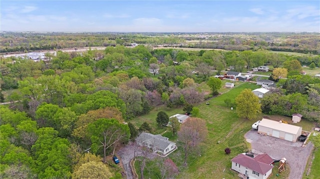 birds eye view of property featuring a wooded view