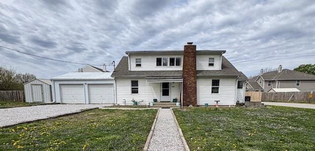 view of front of property featuring driveway, a chimney, an attached garage, and fence