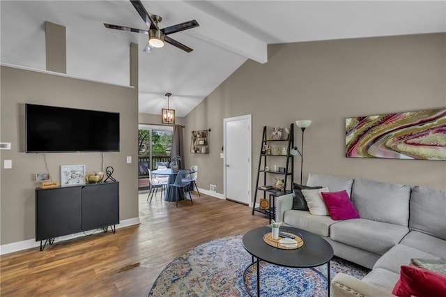 living area with wood finished floors, beamed ceiling, baseboards, high vaulted ceiling, and ceiling fan with notable chandelier
