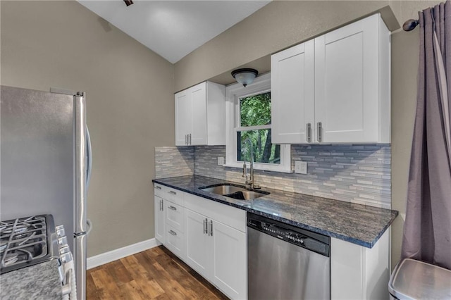 kitchen featuring a sink, white cabinets, backsplash, and stainless steel appliances
