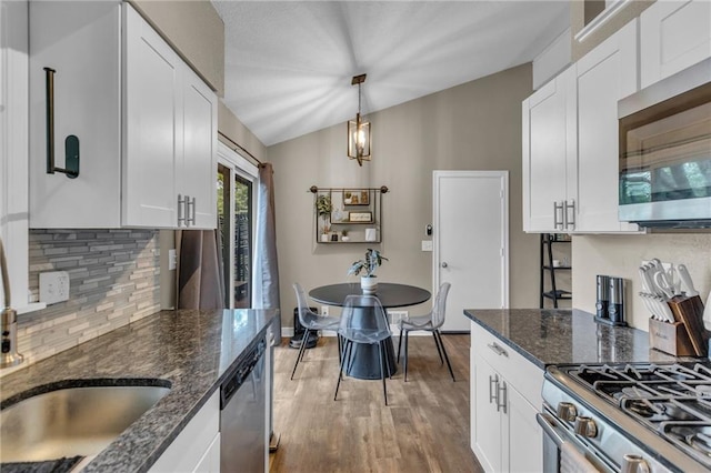 kitchen featuring backsplash, stainless steel appliances, and white cabinetry