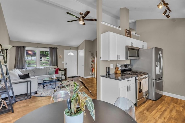 kitchen featuring light wood-type flooring, appliances with stainless steel finishes, white cabinets, and ceiling fan