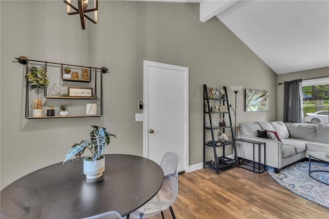 dining room featuring baseboards, beam ceiling, wood finished floors, and high vaulted ceiling