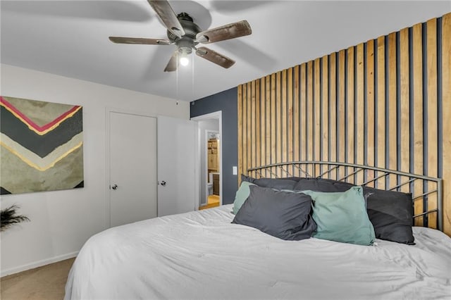 bedroom featuring baseboards, a ceiling fan, and carpet