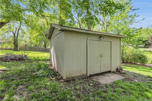 view of shed featuring fence