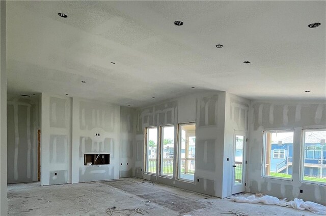 1226 NE 122nd St, Kansas City, MO 64165 - unfurnished living room with a textured ceiling