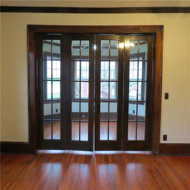 101 E 3rd St, Stanberry, MO 64489 - doorway to outside with baseboards, ornamental molding, and wood finished floors