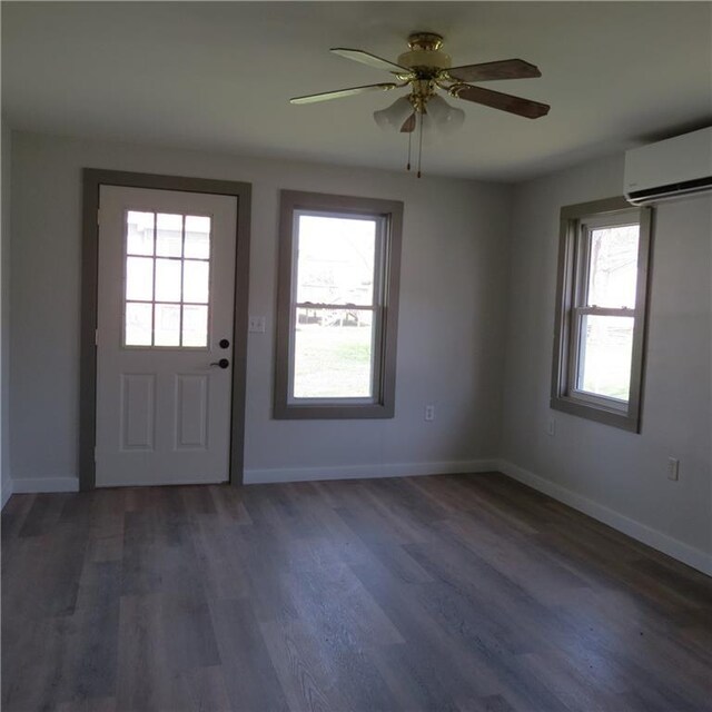 101 E 3rd St, Stanberry, MO 64489 - interior space featuring a wall mounted air conditioner, a wealth of natural light, and wood finished floors