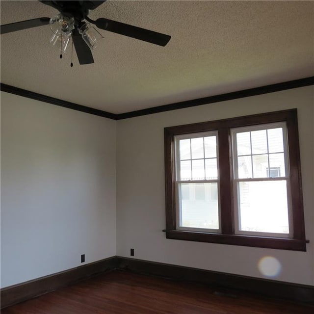 101 E 3rd St, Stanberry, MO 64489 - spare room featuring a textured ceiling, crown molding, baseboards, dark wood-type flooring, and a ceiling fan