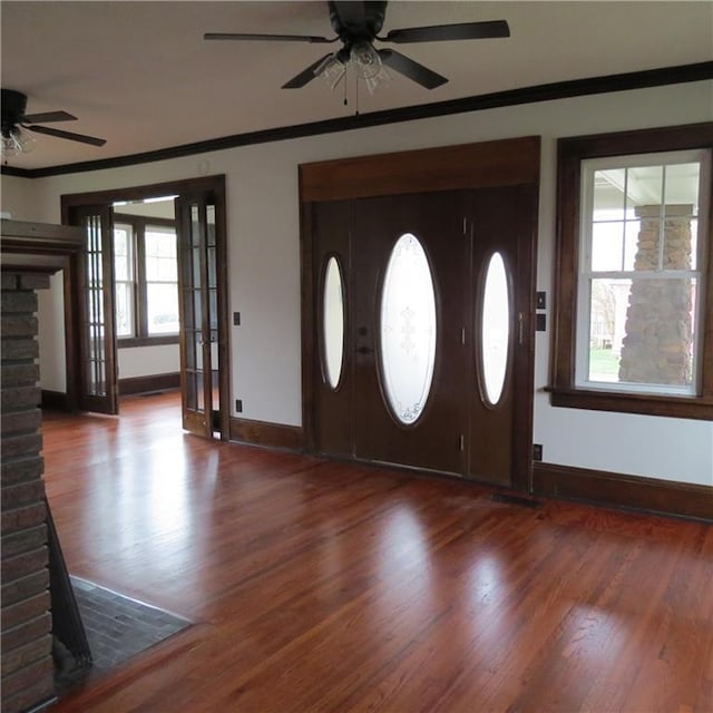 101 E 3rd St, Stanberry, MO 64489 - foyer featuring wood finished floors, a ceiling fan, crown molding, and baseboards