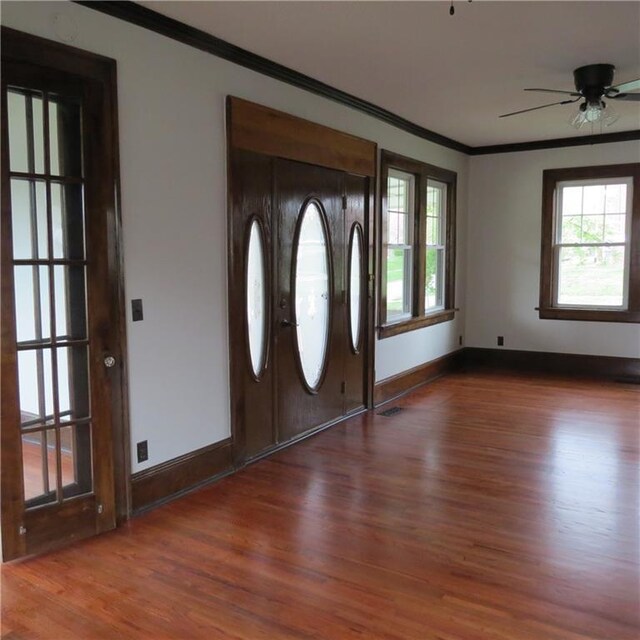 101 E 3rd St, Stanberry, MO 64489 - entryway with baseboards, wood finished floors, a ceiling fan, and crown molding