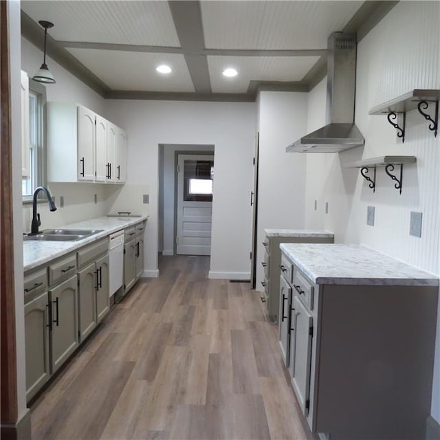 101 E 3rd St, Stanberry, MO 64489 - kitchen with wall chimney range hood, light countertops, white dishwasher, and a sink