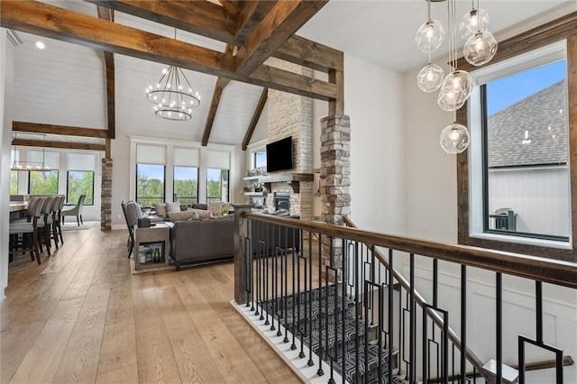 325 Ambersham Dr, Lees Summit, MO 64081 - hall featuring a chandelier, light wood-style floors, and an upstairs landing