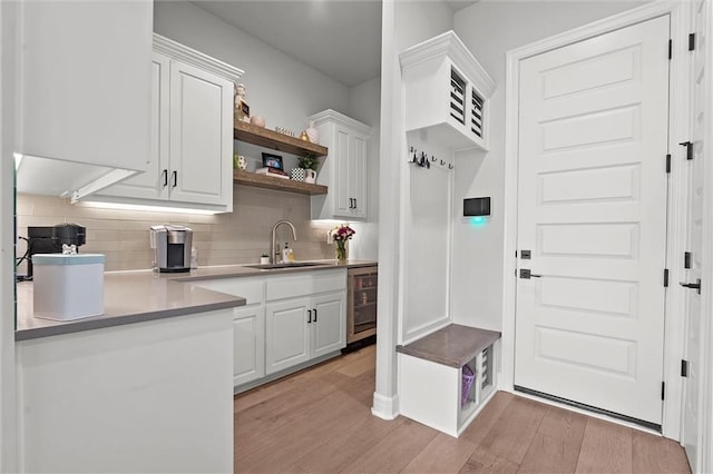 325 Ambersham Dr, Lees Summit, MO 64081 - mudroom featuring a sink, beverage cooler, and light wood finished floors