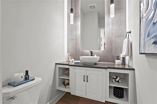 325 Ambersham Dr, Lees Summit, MO 64081 - half bathroom with toilet, wood finished floors, vanity, and baseboards