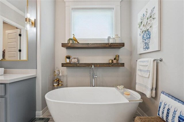 325 Ambersham Dr, Lees Summit, MO 64081 - bathroom with baseboards, a freestanding tub, and vanity