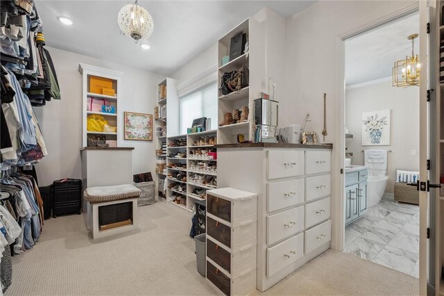 325 Ambersham Dr, Lees Summit, MO 64081 - spacious closet featuring a chandelier and marble finish floors