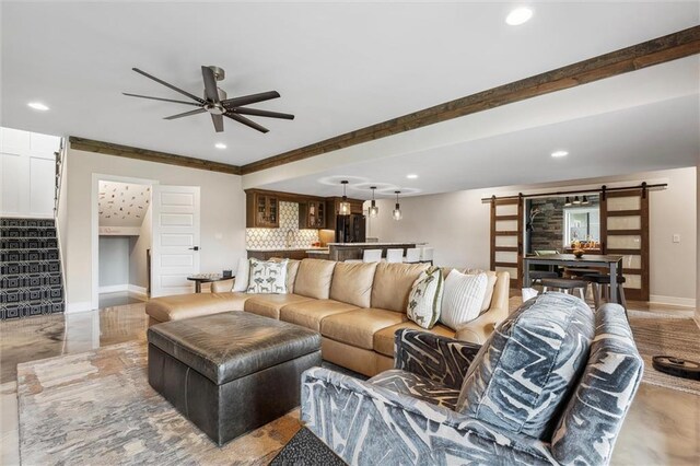 325 Ambersham Dr, Lees Summit, MO 64081 - living area featuring a barn door, stairway, recessed lighting, a ceiling fan, and baseboards