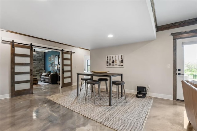 325 Ambersham Dr, Lees Summit, MO 64081 - dining room with a barn door, baseboards, concrete flooring, and recessed lighting