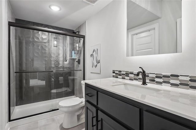 325 Ambersham Dr, Lees Summit, MO 64081 - full bathroom with toilet, tasteful backsplash, vanity, and a shower stall