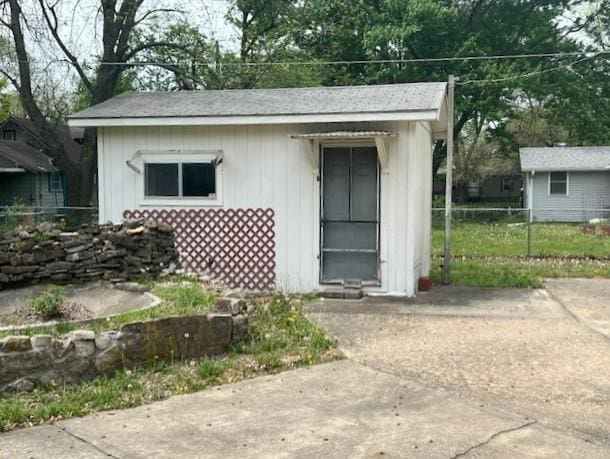 view of outbuilding featuring fence