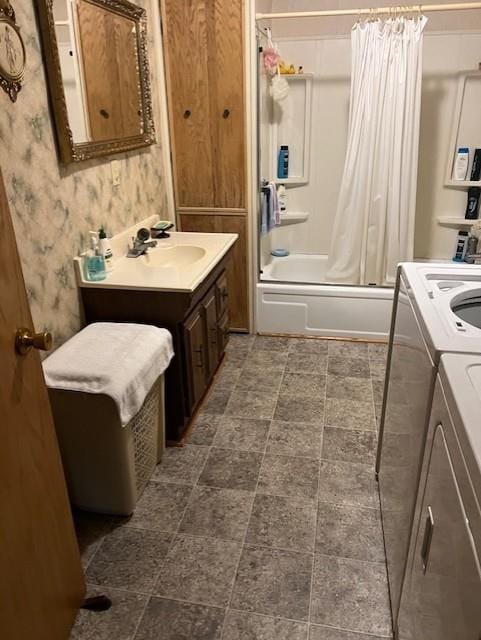 bathroom with washing machine and clothes dryer, shower / bathtub combination with curtain, water heater, and vanity