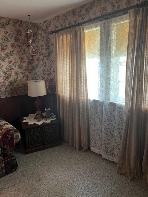 carpeted bedroom with wallpapered walls