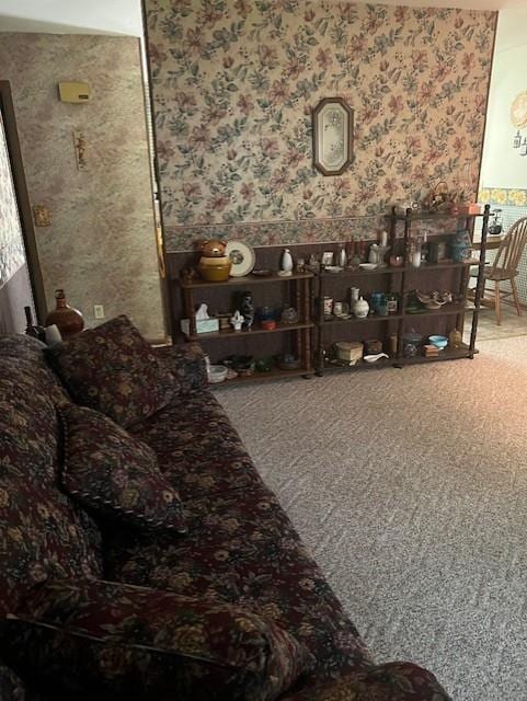 carpeted living area featuring wallpapered walls