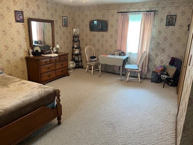 bedroom featuring light carpet and wallpapered walls