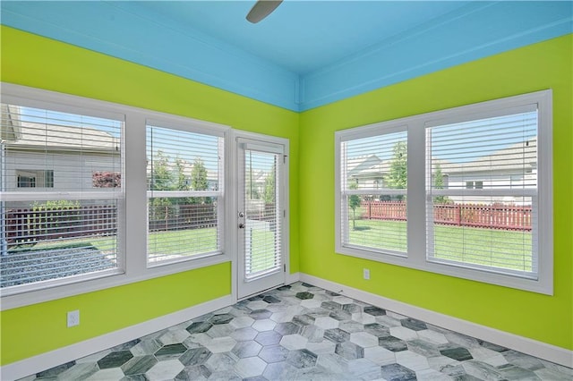 unfurnished sunroom with baseboards
