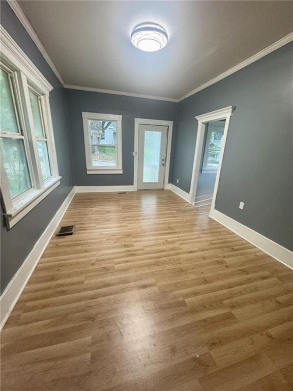 2016 Scott St, Saint Joseph, MO 64507 - empty room with baseboards, light wood finished floors, and crown molding