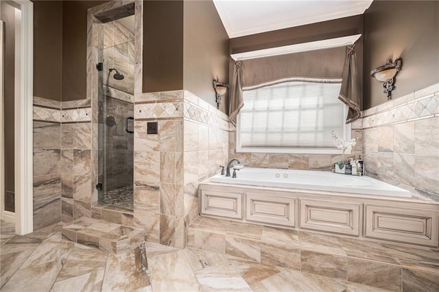 bathroom with crown molding, tile walls, a garden tub, and a stall shower