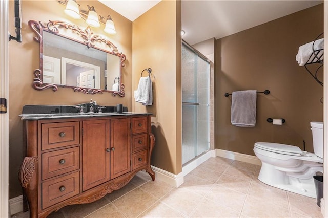 bathroom featuring a stall shower, tile patterned floors, vanity, baseboards, and toilet
