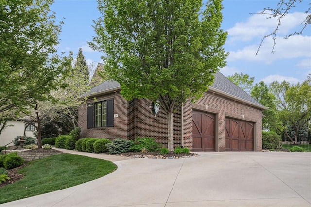 view of front of house with concrete driveway, brick siding, and a garage