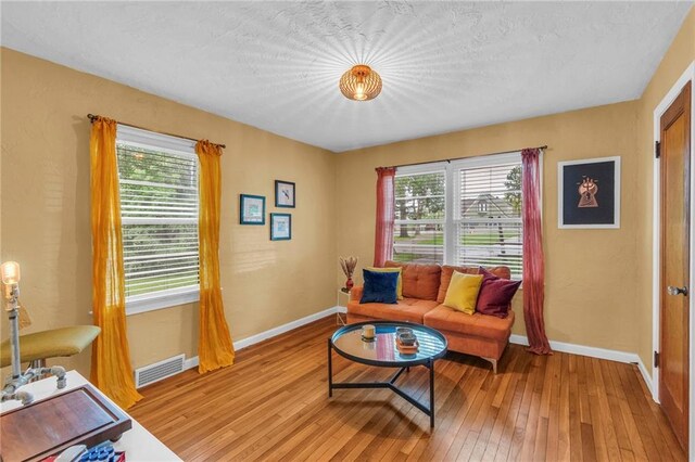 living room with light wood-style flooring and baseboards