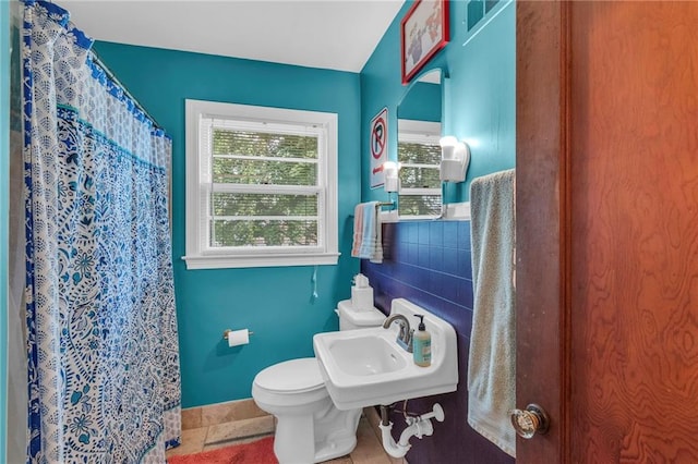 bathroom with a sink, toilet, baseboards, and a shower with shower curtain