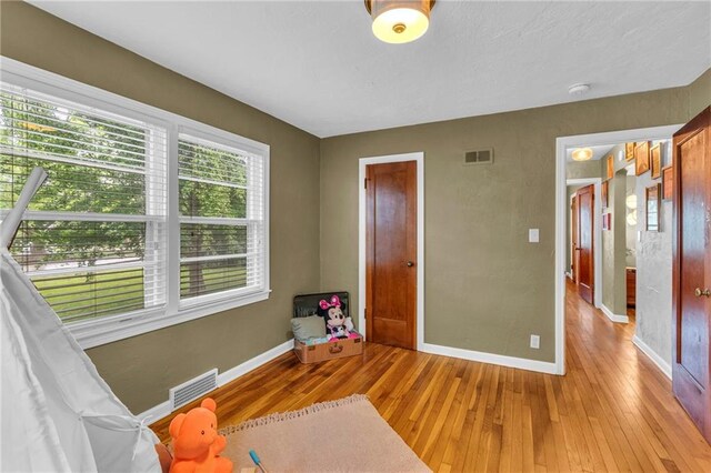 unfurnished bedroom featuring light wood finished floors and baseboards