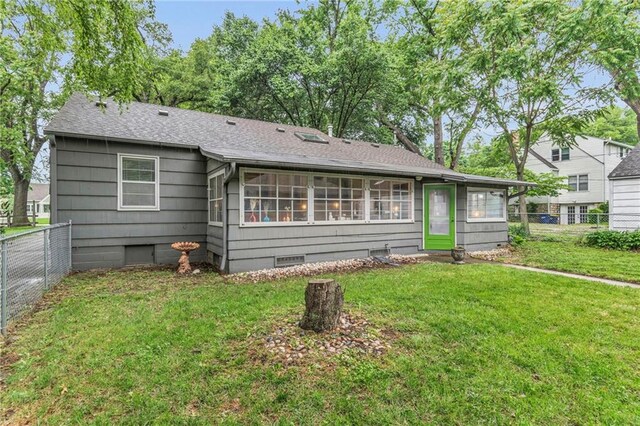 rear view of house with roof with shingles and crawl space