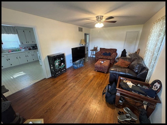 708 Highland Ave, Warrensburg, MO 64093 - living area with ceiling fan, visible vents, and wood finished floors