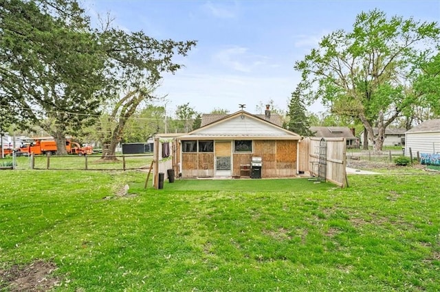 6425 N Edison Ave, Kansas City, MO 64151 - rear view of property featuring a chimney, fence, and a yard