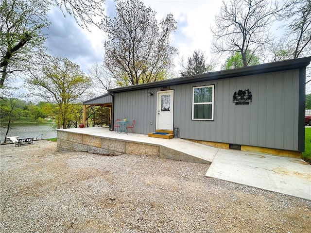 58 E Sugar Lake Cv, Mound City, KS 66056 - view of front facade featuring a patio and board and batten siding