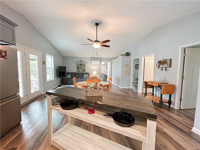 58 E Sugar Lake Cv, Mound City, KS 66056 - dining space with baseboards, wood finished floors, ceiling fan, and lofted ceiling