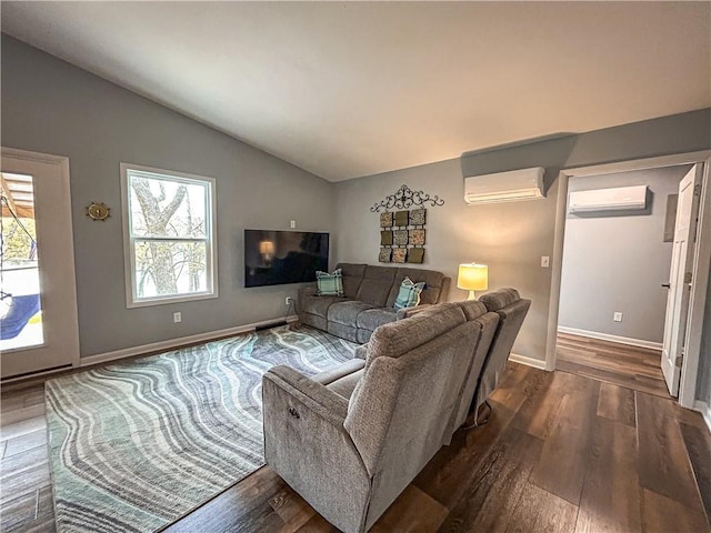 58 E Sugar Lake Cv, Mound City, KS 66056 - living room featuring a wall unit AC, lofted ceiling, and dark wood finished floors