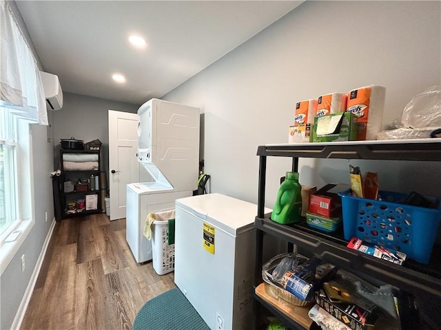 58 E Sugar Lake Cv, Mound City, KS 66056 - laundry room featuring wood finished floors, laundry area, stacked washer / dryer, a wall mounted air conditioner, and baseboards