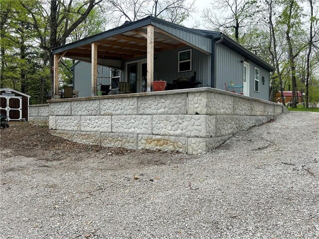 58 E Sugar Lake Cv, Mound City, KS 66056 - rear view of property with an outdoor structure and a shed